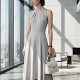 A style comparison of two elegant tailored midi dresses with a flowing high-low hem; the left showcasing a sophisticated light grey dress with a structured collared capelet sleeve, and the right featuring a vibrant purple sleeveless dress with refined pleated neckline and side pockets.