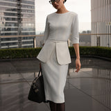 A style comparison of three elegant women modeling tailored three-quarter sleeve crew-neck pencil midi dresses; featured in ivory white and blush pink with a subtle peplum waist and crystal bar detail, and in navy blue with a clean minimalist sheath silhouette.