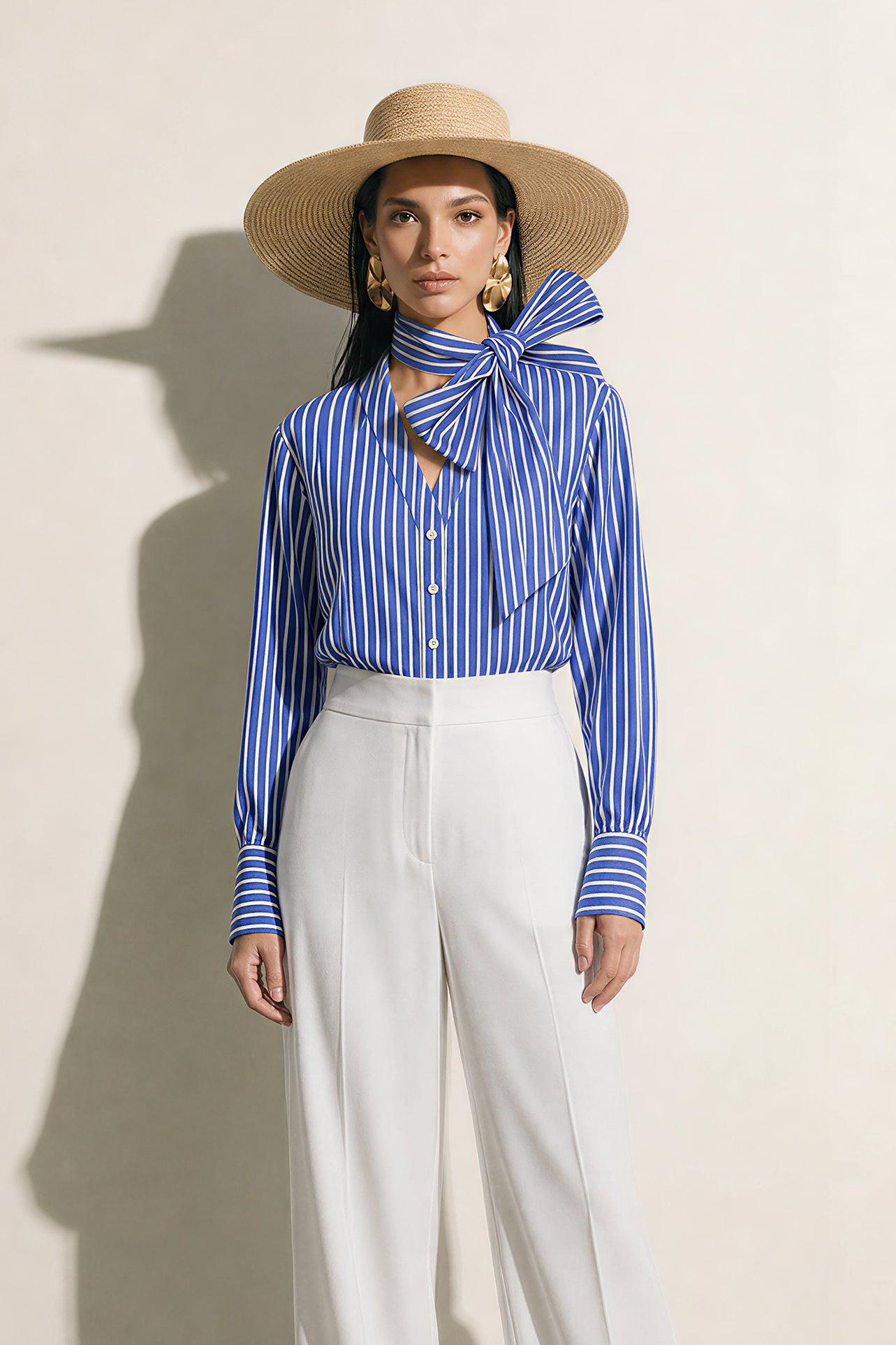 A style collection of three models presenting elegant dopamine office wear; the left in a white bow-tie blouse with a mustard yellow front-slit midi skirt, the center wearing a blue striped pussy-bow shirt with a straw hat and white wide-leg trousers, and the right in a vibrant orange satin blouse with a royal blue pencil skirt