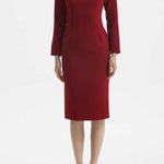 A professional woman wearing a sophisticated black long-sleeve midi dress, featuring a unique notched square neckline and a tailored slim-fit pencil silhouette for a polished executive office look.