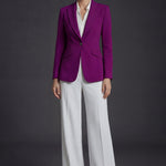 A professional woman wearing a sophisticated black belted blazer dress, featuring a tailored slim-fit silhouette with a waist-defining belt for a powerful executive business look.