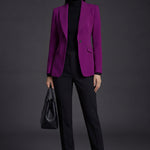 A professional woman wearing a sophisticated black belted blazer dress, featuring a tailored slim-fit silhouette with a waist-defining belt for a powerful executive business look.