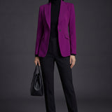 A professional woman wearing a sophisticated black belted blazer dress, featuring a tailored slim-fit silhouette with a waist-defining belt for a powerful executive business look.