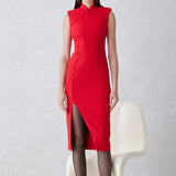 A professional woman wearing a sophisticated black modern qipao, featuring a classic mandarin collar, sleeveless slim-fit silhouette, and elegant side buttons with a high-low slit for a timeless oriental chic look.