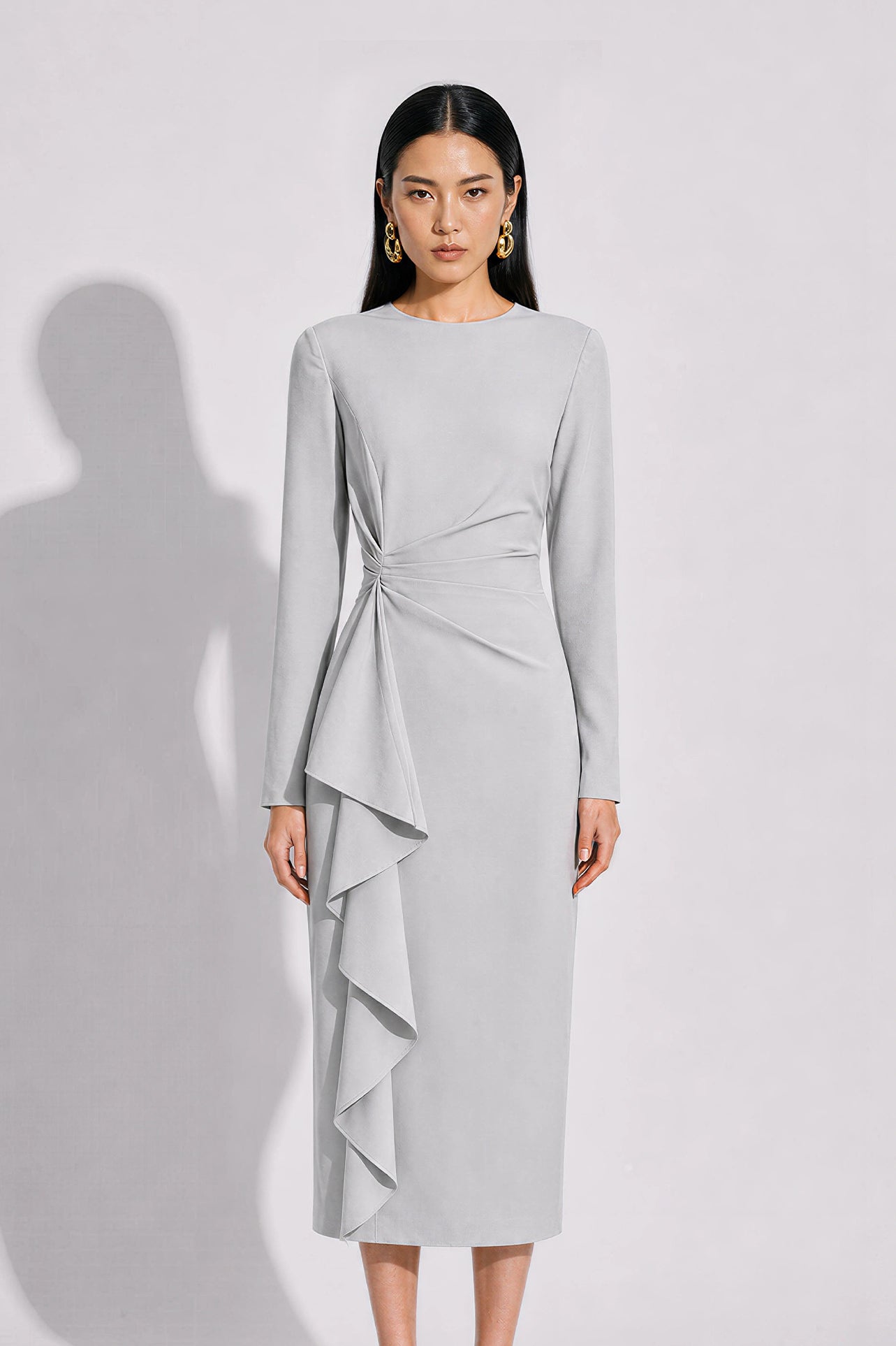 A style comparison of two elegant tailored long-sleeve midi dresses with side twist knotting and cascading ruffles; the left in a sophisticated light dove grey and the right in a vibrant royal blu
