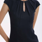 A professional woman wearing a sophisticated navy blue midi dress, featuring an elegant pleated neckline with a subtle keyhole detail and a tailored slim-fit pencil silhouette for a polished executive look.