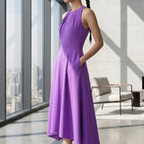 A style comparison of two elegant tailored midi dresses with a flowing high-low hem; the left showcasing a sophisticated light grey dress with a structured collared capelet sleeve, and the right featuring a vibrant purple sleeveless dress with refined pleated neckline and side pockets.
