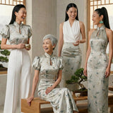 A beautiful woman modeling an elegant sleeveless modern qipao dress, featuring a champagne satin finish with dark green bamboo leaf prints and a sophisticated mandarin collar.
