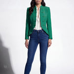 A professional woman wearing a stunning vibrant green blazer, featuring a traditional mandarin collar and elegant frog button detailing for a modern oriental-inspired executive look.