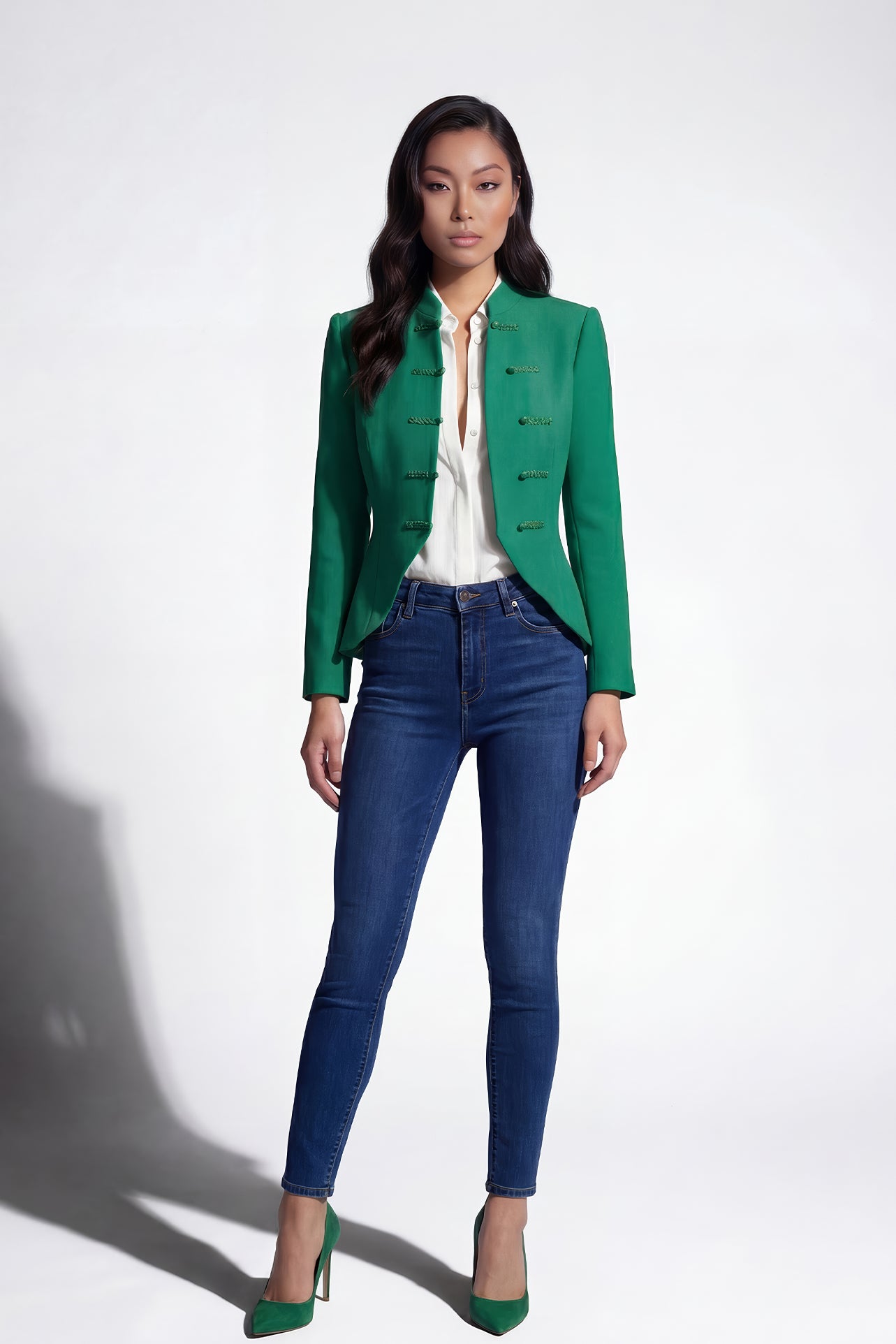A professional woman wearing a stunning vibrant green blazer, featuring a traditional mandarin collar and elegant frog button detailing for a modern oriental-inspired executive look.