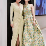 A sophisticated woman wearing a vibrant magenta long-sleeve dress, featuring a plunging V-neckline and an elegant knot-front twist at the waist for a stunning evening gala look.