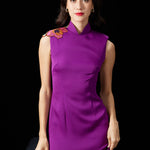 A professional woman wearing a stunning purple satin sleeveless dress, featuring a traditional mandarin collar and delicate floral embroidery on the shoulder for a modern oriental-inspired formal look.