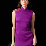 A professional woman wearing a stunning purple satin sleeveless dress, featuring a traditional mandarin collar and delicate floral embroidery on the shoulder for a modern oriental-inspired formal look.