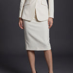 A professional woman wearing a sophisticated high-waisted pencil skirt in a cream white color, featuring a tailored slim fit and knee-length hem for an elegant office look.