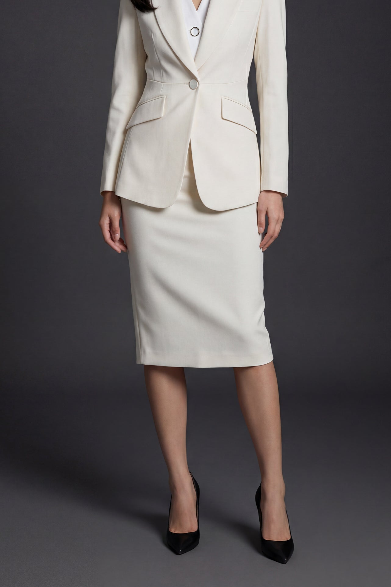 A professional woman wearing a sophisticated high-waisted pencil skirt in a cream white color, featuring a tailored slim fit and knee-length hem for an elegant office look.