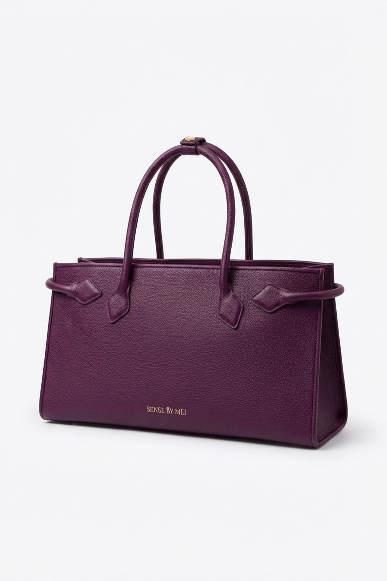 A sophisticated plum purple tote bag crafted from premium pebbled leather, displayed next to a matching shade of luxury lipstick, representing an elegant executive fashion set.